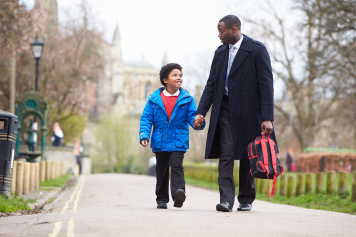 man and son walk to school