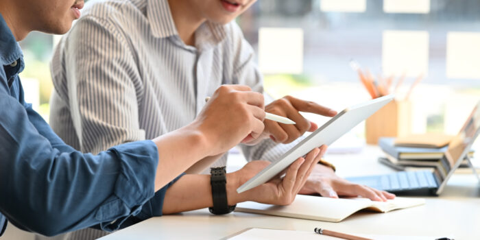 2 workers looking at tablet