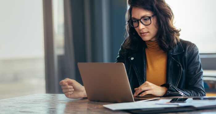 woman reading article on laptop