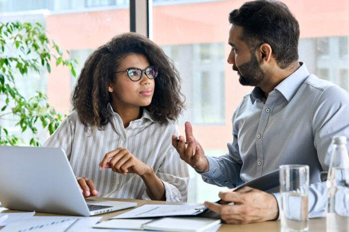 man and woman discuss work
