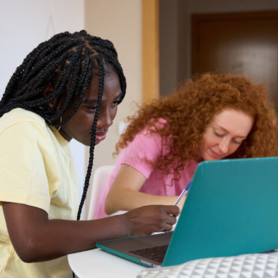 young girl works on laptop