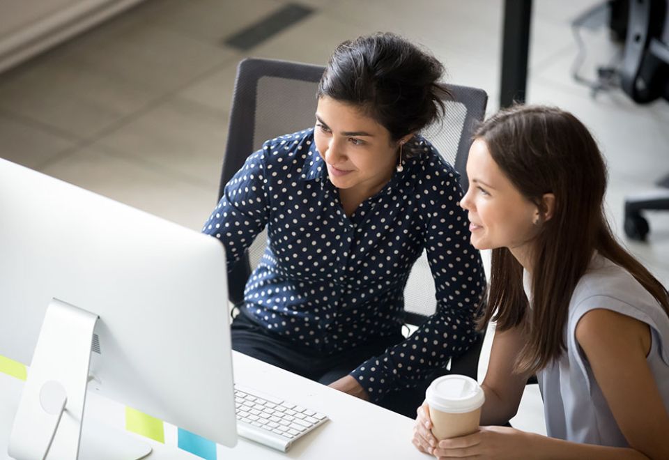 two women work on PC