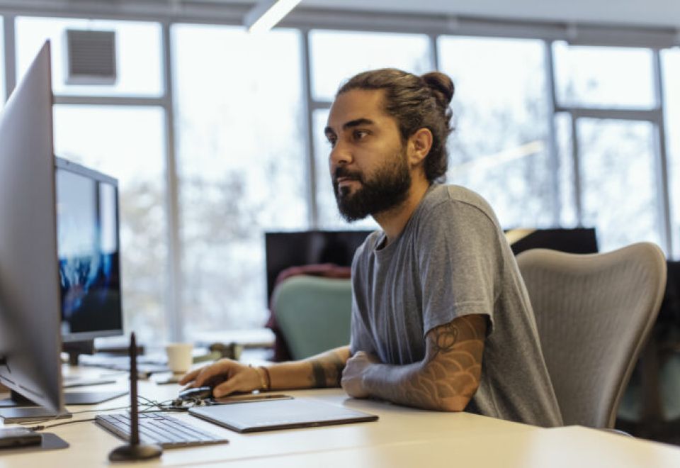 man works on computer