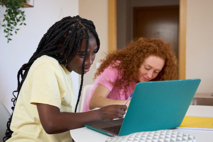 young girl works on laptop