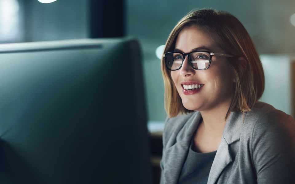 woman happy looking at PC