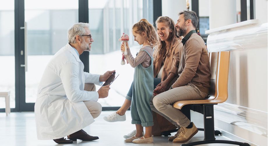 A doctor converses with a family in a hospital setting, discussing medical care and support for a patient.  