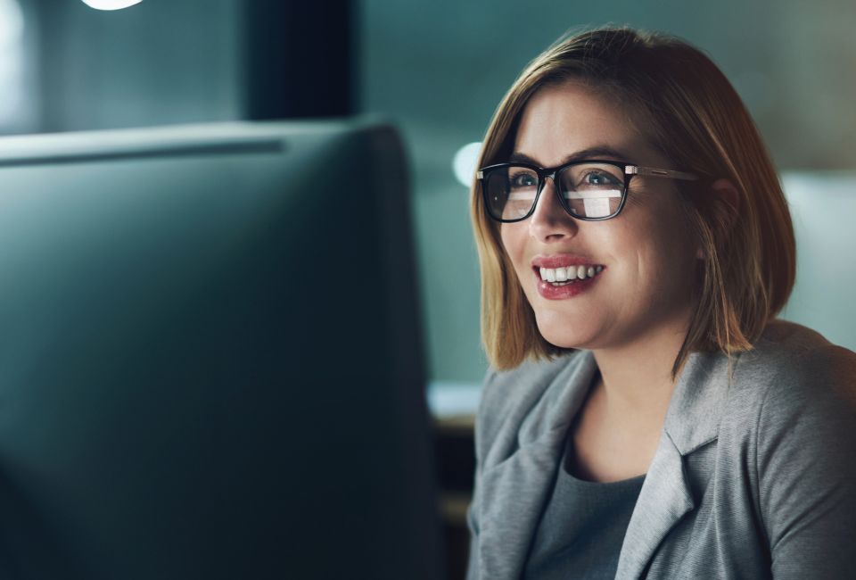 woman happy looking at PC