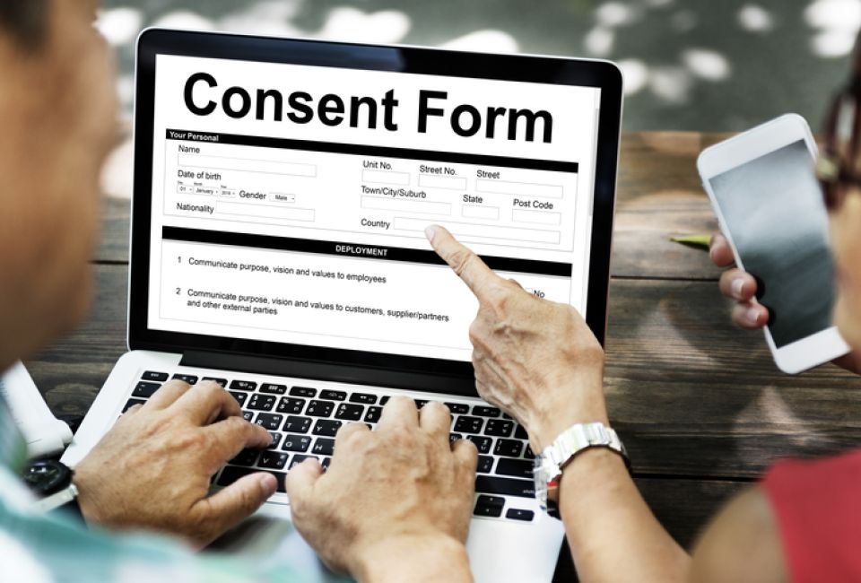 two adults look at consent form