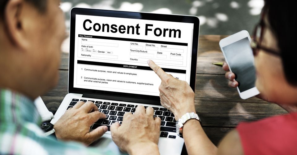 two adults look at consent form